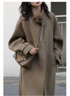 Polished long coat with turtleneck collar and contemporary lace-up details