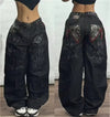 Relaxed fit wide-leg jeans showcasing vibrant street art-inspired design.