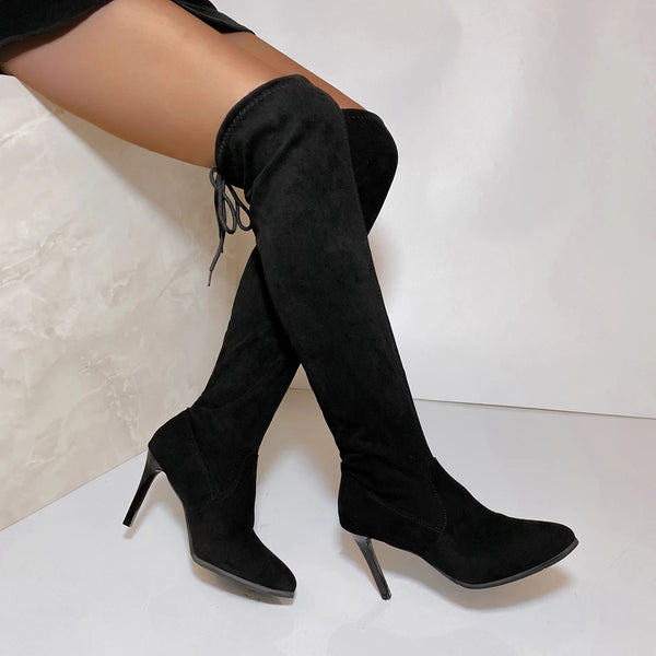 Statement suede boots extending over the knee with thin high heels and adjustable lacing detail