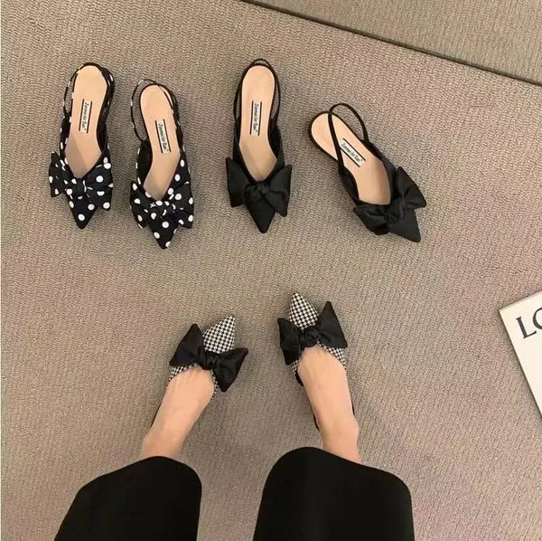 Minimalist pointed sandals with feminine bow detail and secure elastic band fit