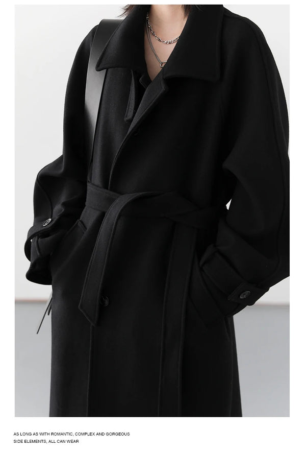 Refined long trench featuring sophisticated collar and flattering waist belt