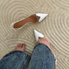 Crystal-clear pointed-toe heels with patent leather details