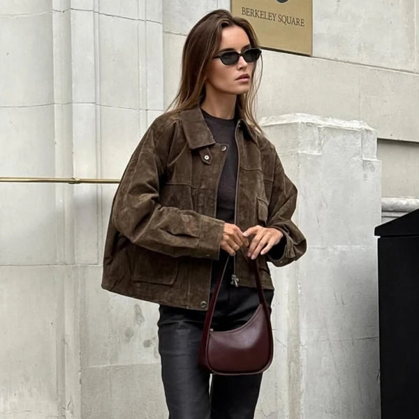 Front view of black faux leather bomber jacket with smooth zipper and athletic silhouette
