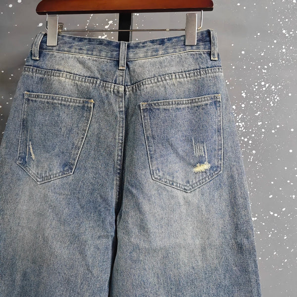 Men's full-length wide leg jeans in washed blue denim with zipper fly