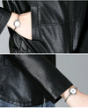 Chic women's sheepskin leather jacket with zippered front, turn-down collar, and pockets for stylish autumn layering.