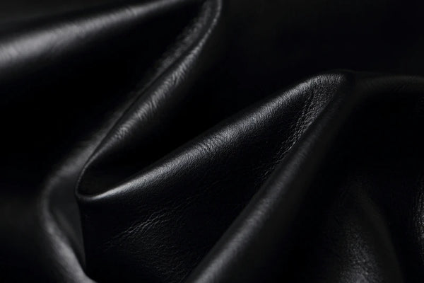 Vintage A2 leather flight jacket draped over a chair, emphasizing its elegance.