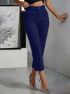 Woman wearing elegant high-waist polyester trousers with ankle-length straight leg cut
