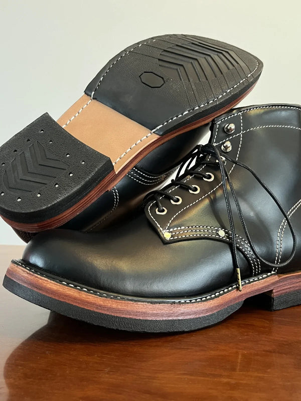 Close-up of the durable rubber sole of handmade leather boots.