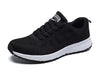 White lace-up running sneakers featuring multi-color design elements