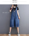 Full length baggy denim jumpsuit with functional pockets styled with sneakers for street style look