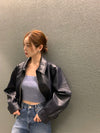 Chic cropped leather jacket for women in premium faux leather, featuring a stylish turn-down collar and secure zipper closure