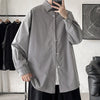 Oversized long sleeve casual shirt for men and women, featuring a Mandarin collar and single-breasted closure in solid color.