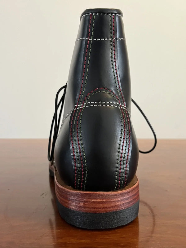 Lace-up closure detail on handcrafted cowhide leather boots.