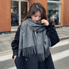 Soft cashmere blend scarf in black, perfect for chilly winter days.