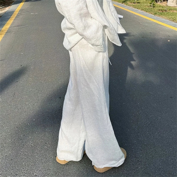 Elegant polyester wide leg trousers with relaxed fit, showing drape and movement of fabric