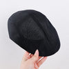 Classic beret that adds a touch of artistry to any outfit.