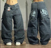 Close-up of artistic embroidery on urban canvas wide-leg jeans.