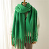 Elegant cashmere-feel scarf in teal with large, fashionable tassels.