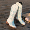 Embroidered mid-calf women's fashion boots with low wedge heel, slip-on design, and durable rubber outsole for comfort.