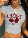 Short sleeve cherry printed crop top in tight fit silhouette perfect for high-waisted bottoms