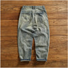 Flat lay of Rebel Spirit Distressed Jeans with outdoor gear, perfect for adventure wear.