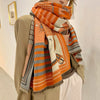 Luxurious cashmere feel scarf draped elegantly around a model's neck.