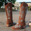 Embroidered mid-calf women's fashion boots with low wedge heel, slip-on design, and durable rubber outsole for comfort.