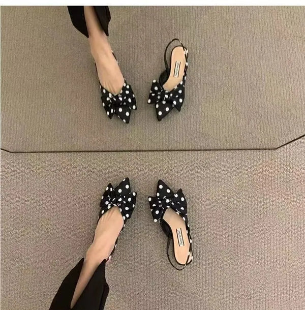 Sophisticated pointed sandals with feminine bow detail and cushioned footbed