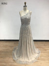 Back view of the one-shoulder beaded gown highlighting its sophisticated silhouette.
