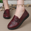 Women's slip-on leather loafers featuring cushioned insole and decorative flower detail