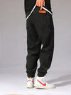 Close-up of ribbed corduroy texture and elastic waistband on thermal joggers