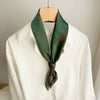 Retro-inspired green satin scarf, suitable for casual and formal attire.