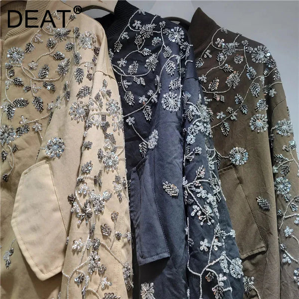 Embroidered sequin jacket with stand-up collar and zipper closure on white background