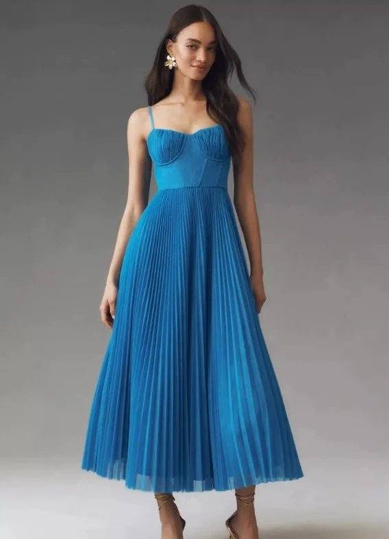 Modern evening dress featuring vintage suspender straps and sophisticated pleated fabric