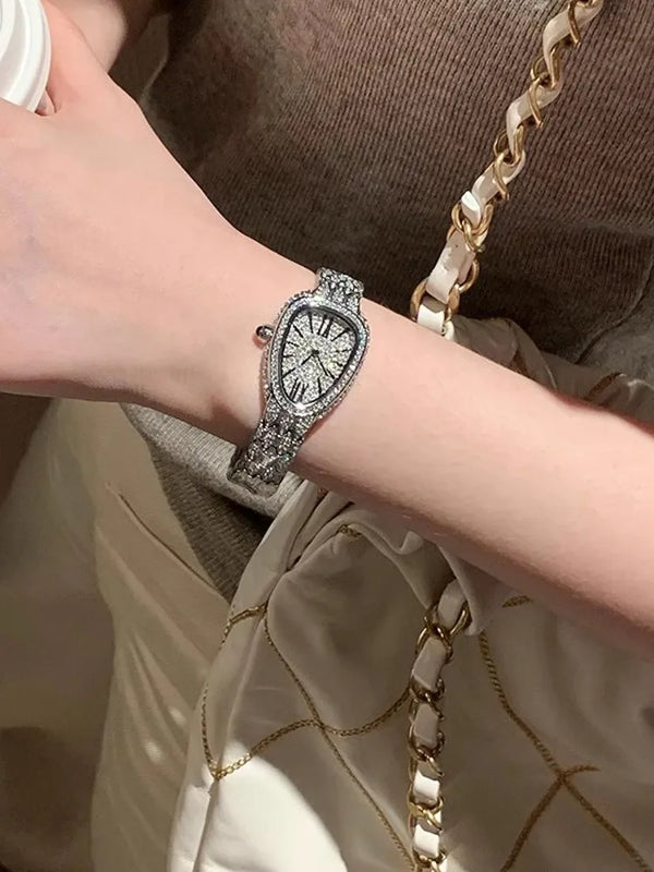 Close-up of the shimmering watch face featuring Roman numerals and diamonds.