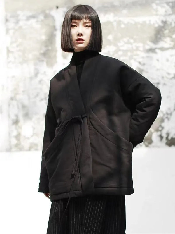 Close-up of cotton padded jacket showing functional deep pockets and premium quilted texture