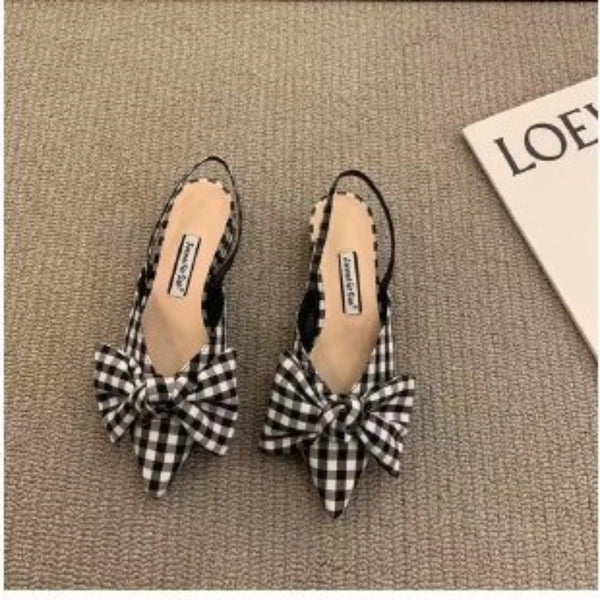 Versatile flat sandals featuring pointed toe, soft sole, and adjustable back strap closure