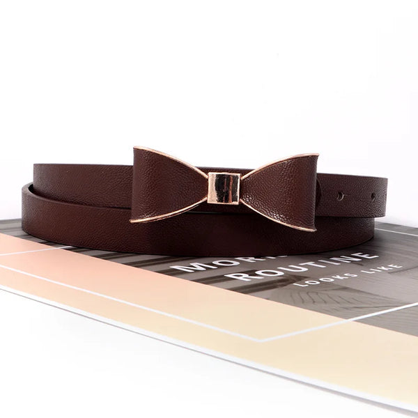 Elegant women's belt with bow detail in faux leather, perfect for casual and formal outfits, featuring a sleek metal buckle.
