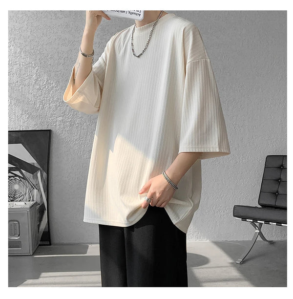 Flat lay of striped summer tee with sunglasses, perfect for summer adventures.