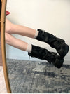 Chic women's mid-calf biker boots with buckle detail, zipper closure, and plush lining for comfort and style in winter.