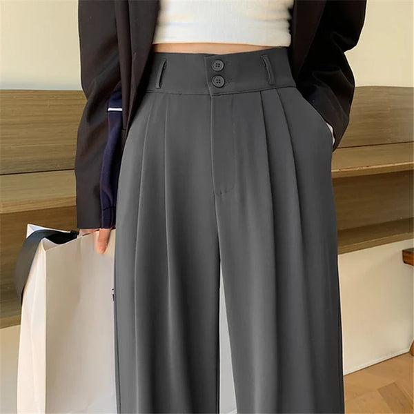 Back view of wide leg trousers displaying flattering fit, functional pockets, and flowing leg cut