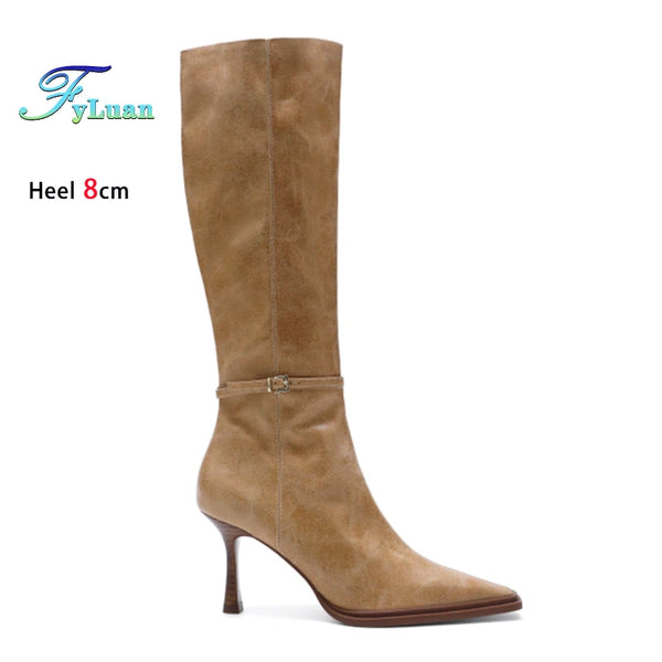 Sophisticated women's knee-high boots with a pointed toe and zip closure.