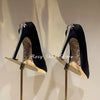 Black leather stiletto pumps with eye-catching crystal embellishments.