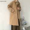 Chic Japanese vintage trench coat for men in black, featuring a single-breasted closure and stylish turn-down collar.