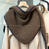 Versatile triangle scarf styled as a shawl, perfect for all seasons.