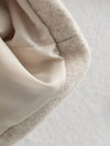 Women's zip-front jacket showing flattering belt placement and elegant drape