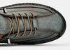 Man's feet in brown leather loafers on urban pavement showing durable traction and grip performance