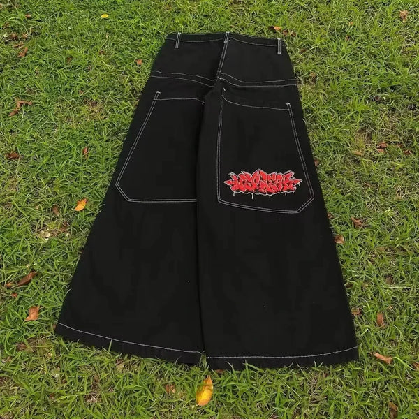 Wide-leg jeans with bold joker pattern, ideal for urban fashion.