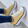 Canvas sneakers in neutral tones arranged in color palette display
