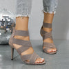 Trendy red stiletto heels with an open toe and ankle-wrap design.